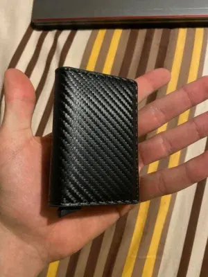 Customer photo of the slim SafeTrack Wallet in one hand